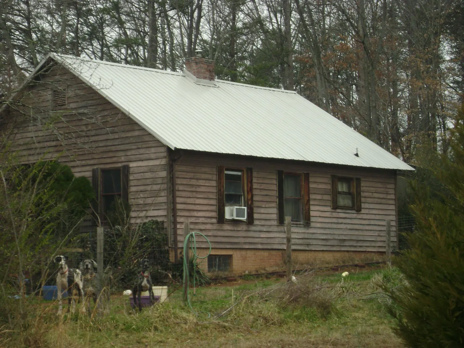 White metal roof on an old wood sided farmhouse, from a Metal Roof Installation job in Interlachen